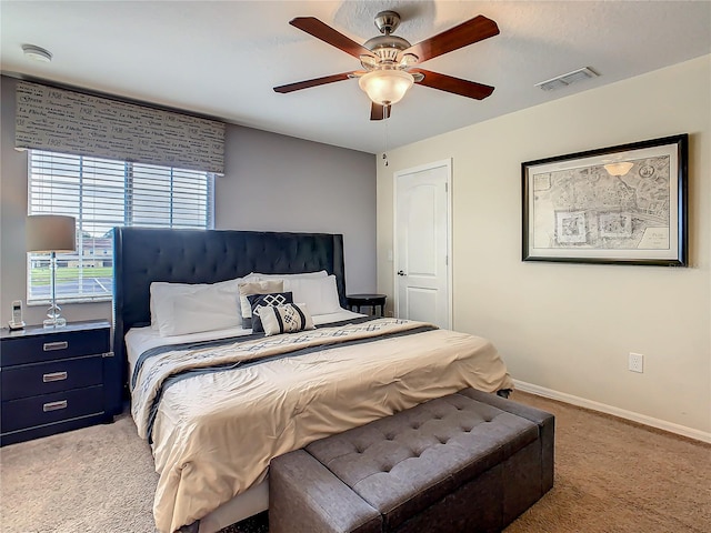 bedroom featuring light carpet and ceiling fan