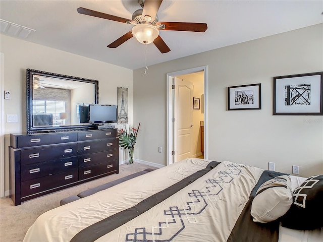 carpeted bedroom featuring ensuite bathroom and ceiling fan