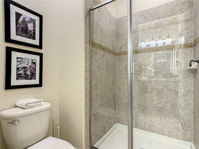 bathroom featuring an enclosed shower and toilet