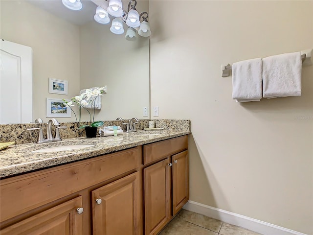 bathroom with tile floors, oversized vanity, and dual sinks