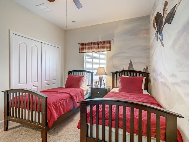 carpeted bedroom featuring a closet and ceiling fan