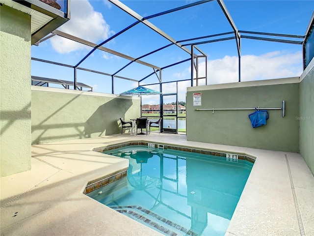 view of pool with a lanai and a patio