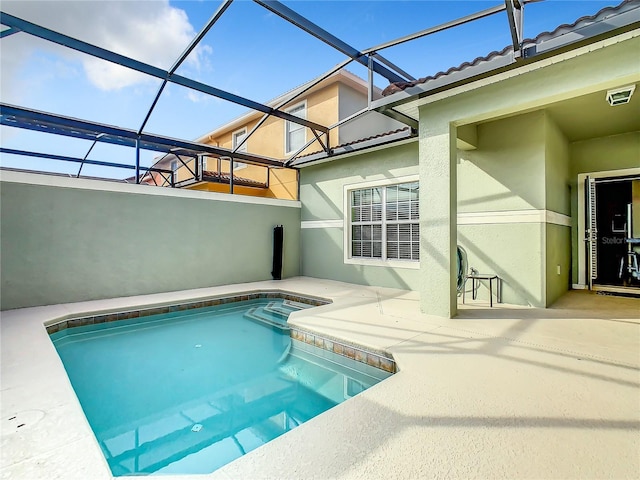 view of pool featuring a lanai and a patio