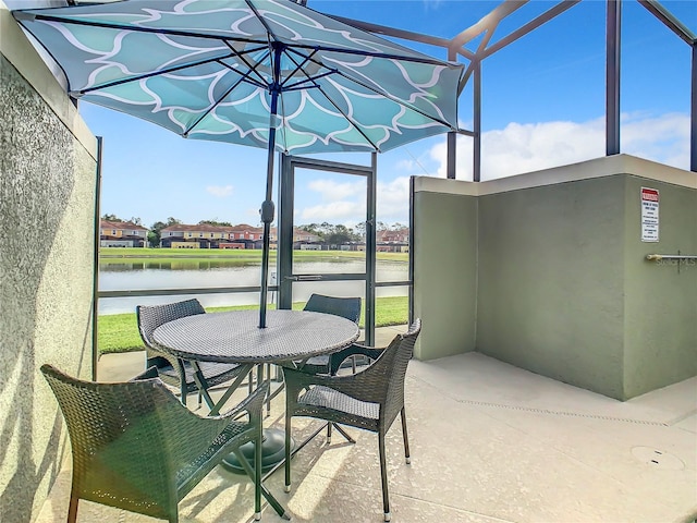 sunroom / solarium featuring a water view