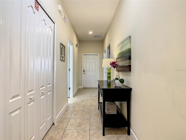 corridor featuring light tile floors