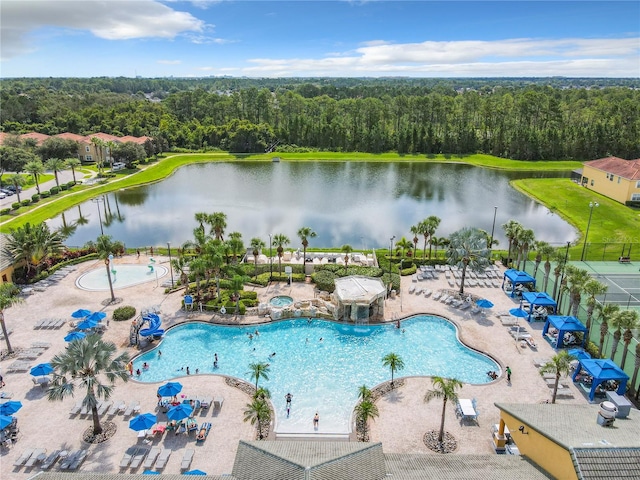 view of swimming pool with a patio area and a water view