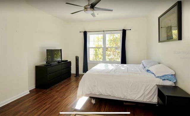 bedroom with ceiling fan and dark wood-type flooring