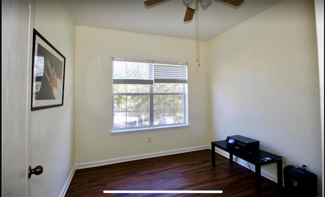 empty room featuring ceiling fan and dark wood-type flooring