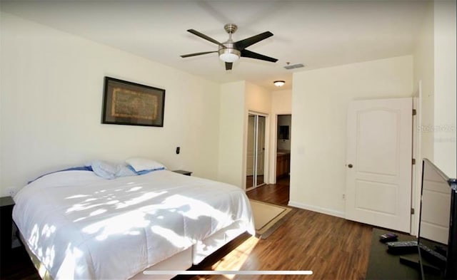 bedroom with ceiling fan and dark hardwood / wood-style floors