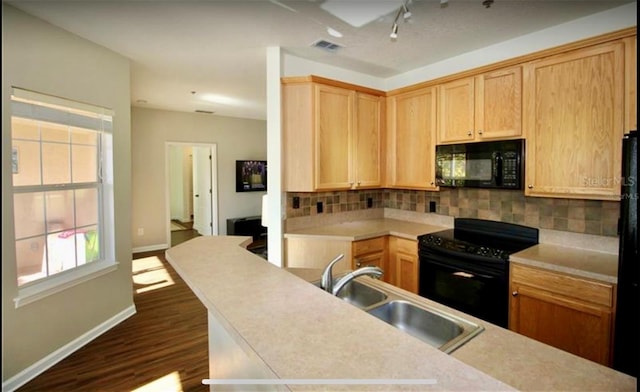 kitchen with backsplash, sink, black appliances, and light brown cabinets