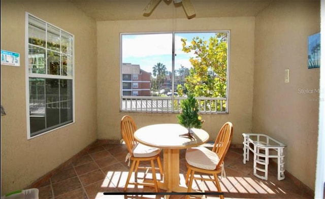 tiled dining area featuring ceiling fan