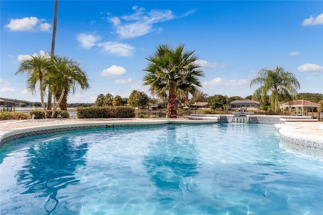 view of swimming pool with a fenced in pool and fence