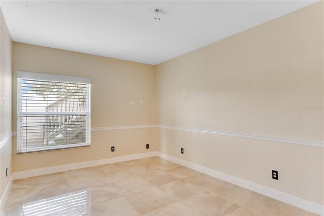 spare room featuring baseboards