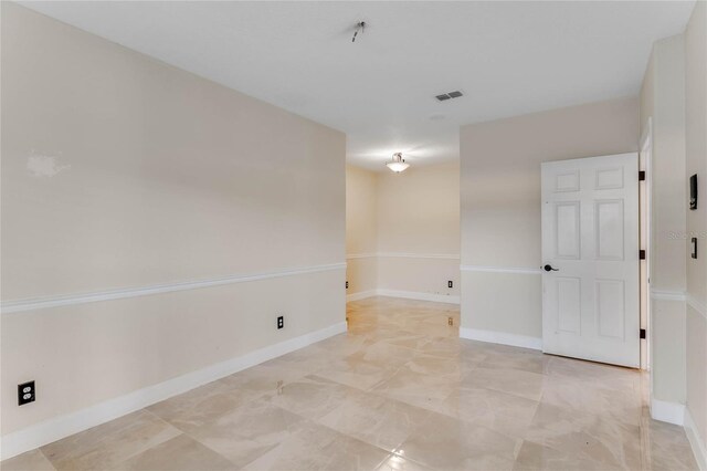 spare room with visible vents and baseboards