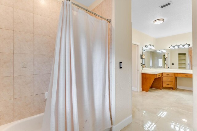 full bath featuring vanity, visible vents, baseboards, shower / bath combo, and tile patterned floors