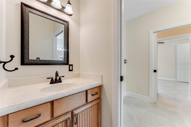 bathroom with vanity and baseboards