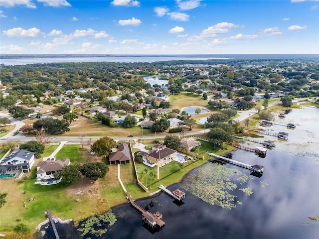 drone / aerial view with a water view and a residential view