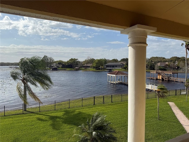 water view featuring fence and a boat dock