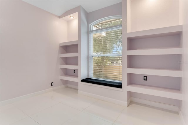 interior space featuring built in features, baseboards, and tile patterned flooring