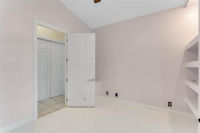 laundry area featuring tile patterned floors and baseboards