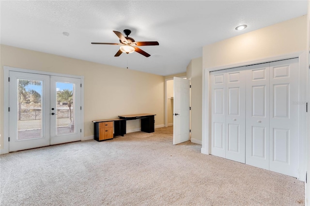 unfurnished bedroom with access to exterior, french doors, light carpet, and baseboards