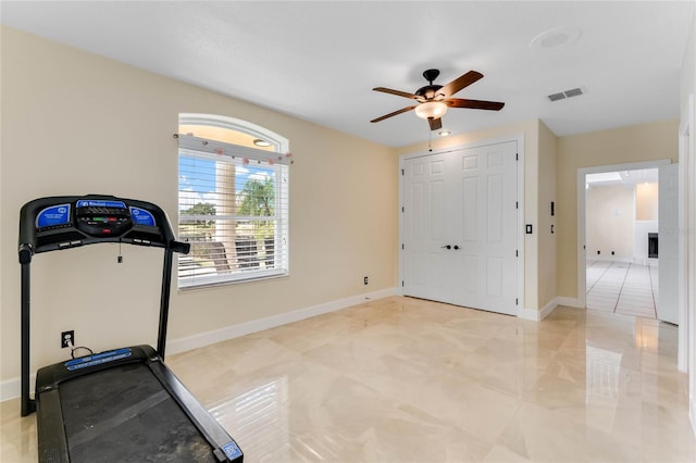 workout room with visible vents, baseboards, and a ceiling fan