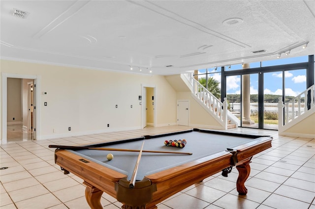 playroom with visible vents, a textured ceiling, and light tile patterned flooring