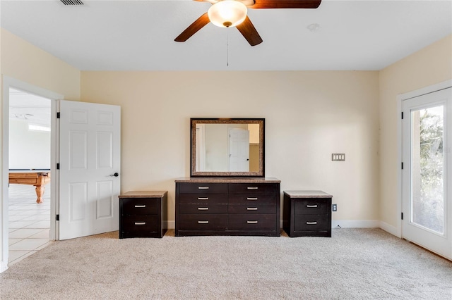 unfurnished bedroom featuring a ceiling fan, light tile patterned flooring, light colored carpet, and baseboards