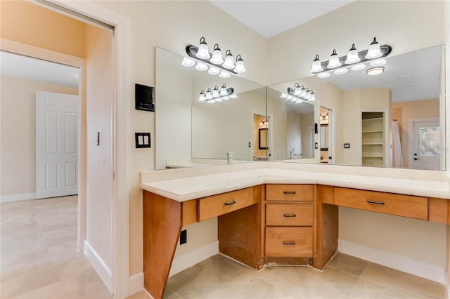 bathroom featuring vanity, baseboards, and tile patterned flooring