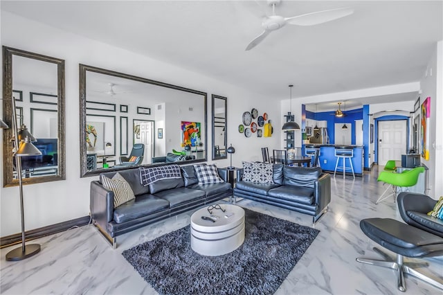 living room with ceiling fan and marble finish floor