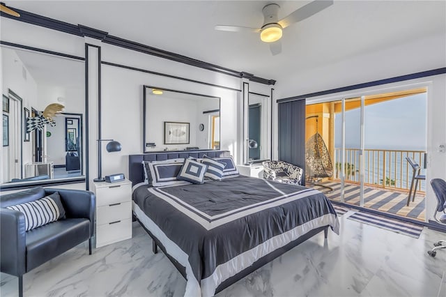 bedroom with ceiling fan, marble finish floor, a barn door, and access to exterior