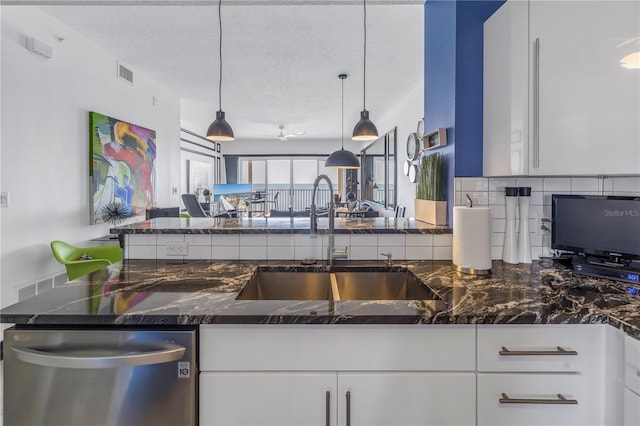 kitchen with dishwasher, white cabinetry, and pendant lighting