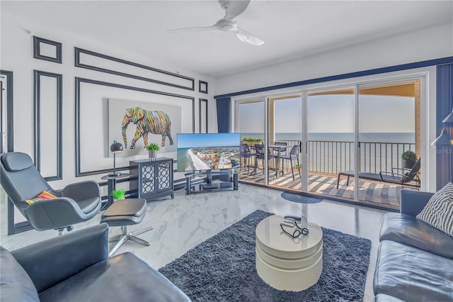 living area featuring ceiling fan and marble finish floor