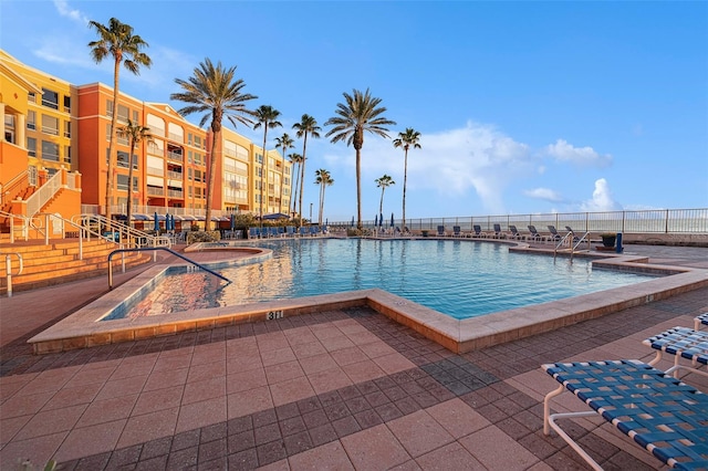 community pool featuring a patio and fence