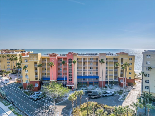 view of property with a water view and uncovered parking