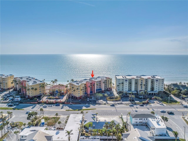 birds eye view of property with a water view and a city view