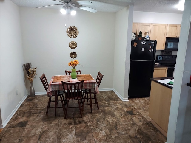 dining space featuring dark tile floors and ceiling fan