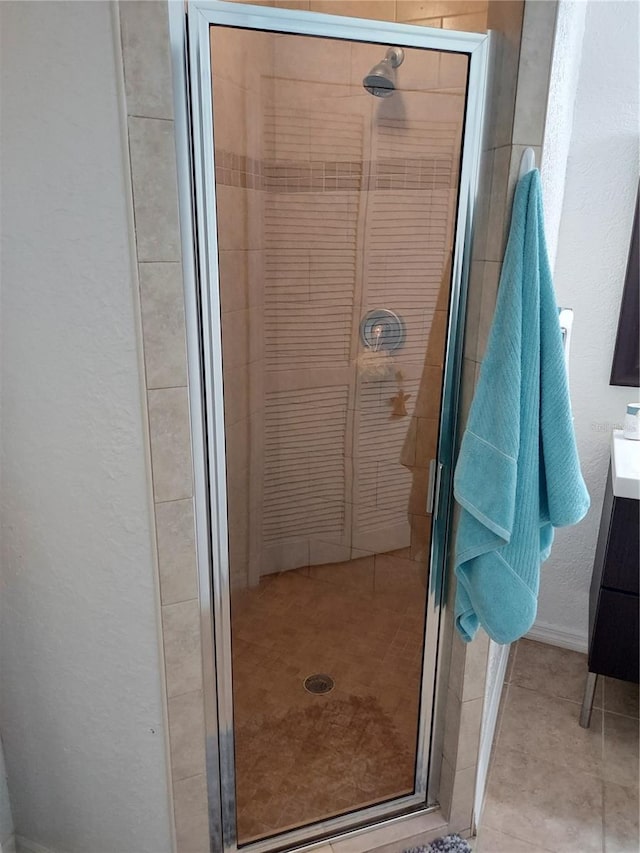 bathroom featuring vanity and a shower with shower door