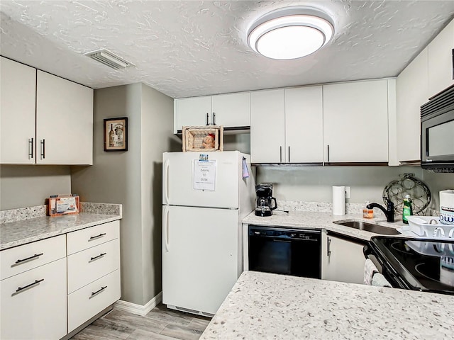 kitchen with light hardwood / wood-style floors, sink, white cabinets, dishwasher, and white refrigerator