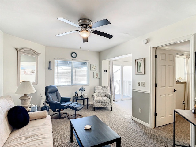 carpeted living room with ceiling fan