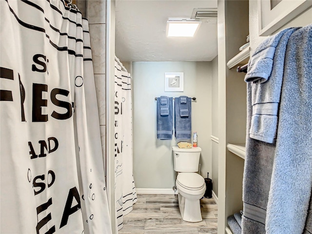 bathroom featuring toilet and hardwood / wood-style floors