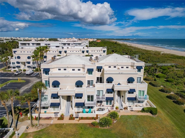 birds eye view of property with a water view and a view of the beach