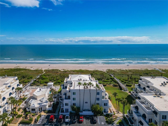 bird's eye view with a water view and a view of the beach