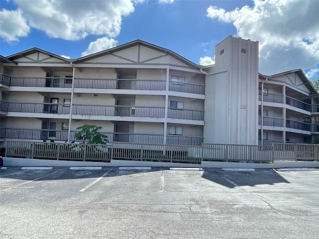 view of property with uncovered parking