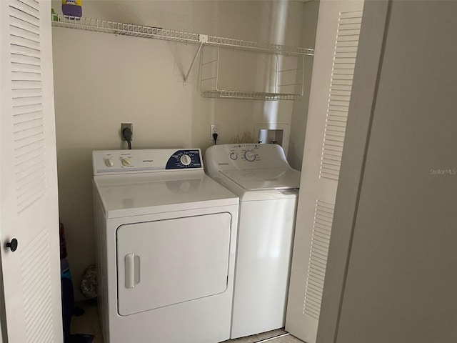 laundry room with washing machine and clothes dryer, hookup for a washing machine, and hookup for an electric dryer