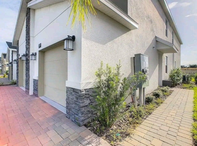 view of side of home featuring a garage