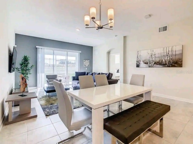 tiled dining area with a chandelier