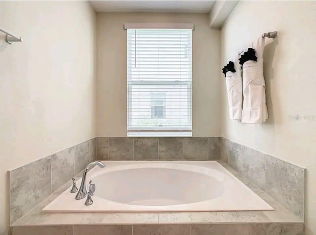 bathroom with tiled tub