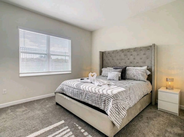 bedroom with dark colored carpet