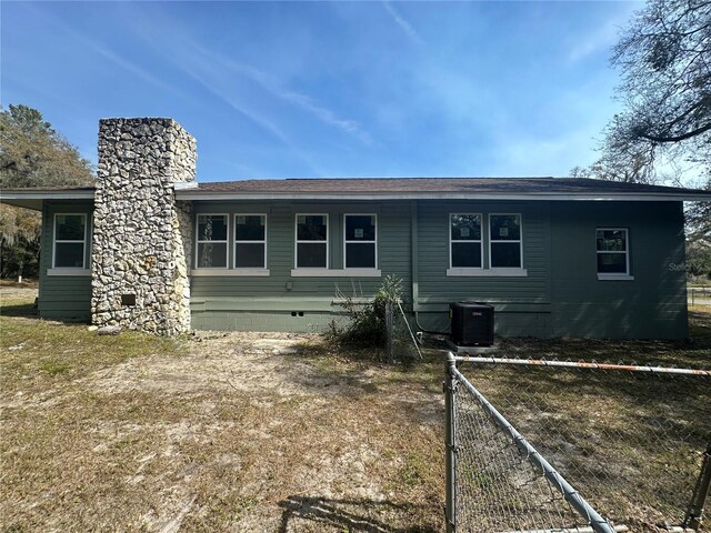 rear view of property featuring central air condition unit